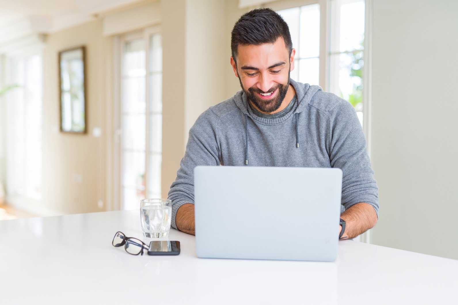 Man smiling working using computer laptop